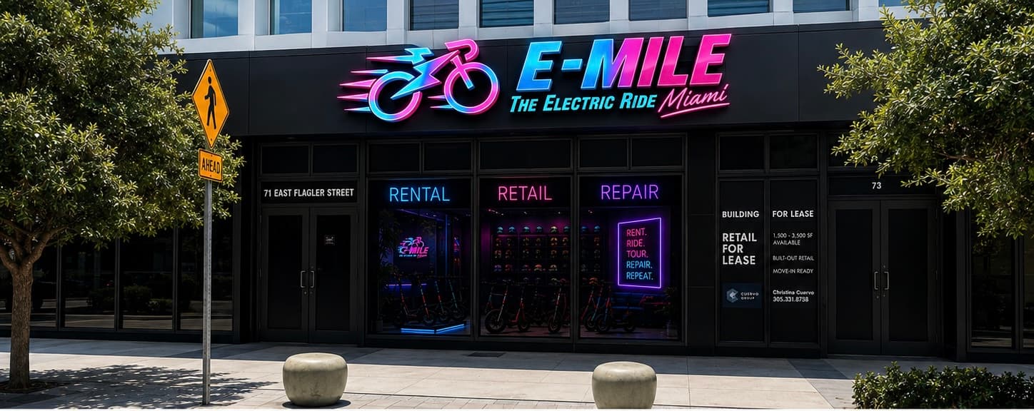 Vibrant neon E-MILE storefront in Miami offering electric ride rentals, retail, and repair services.