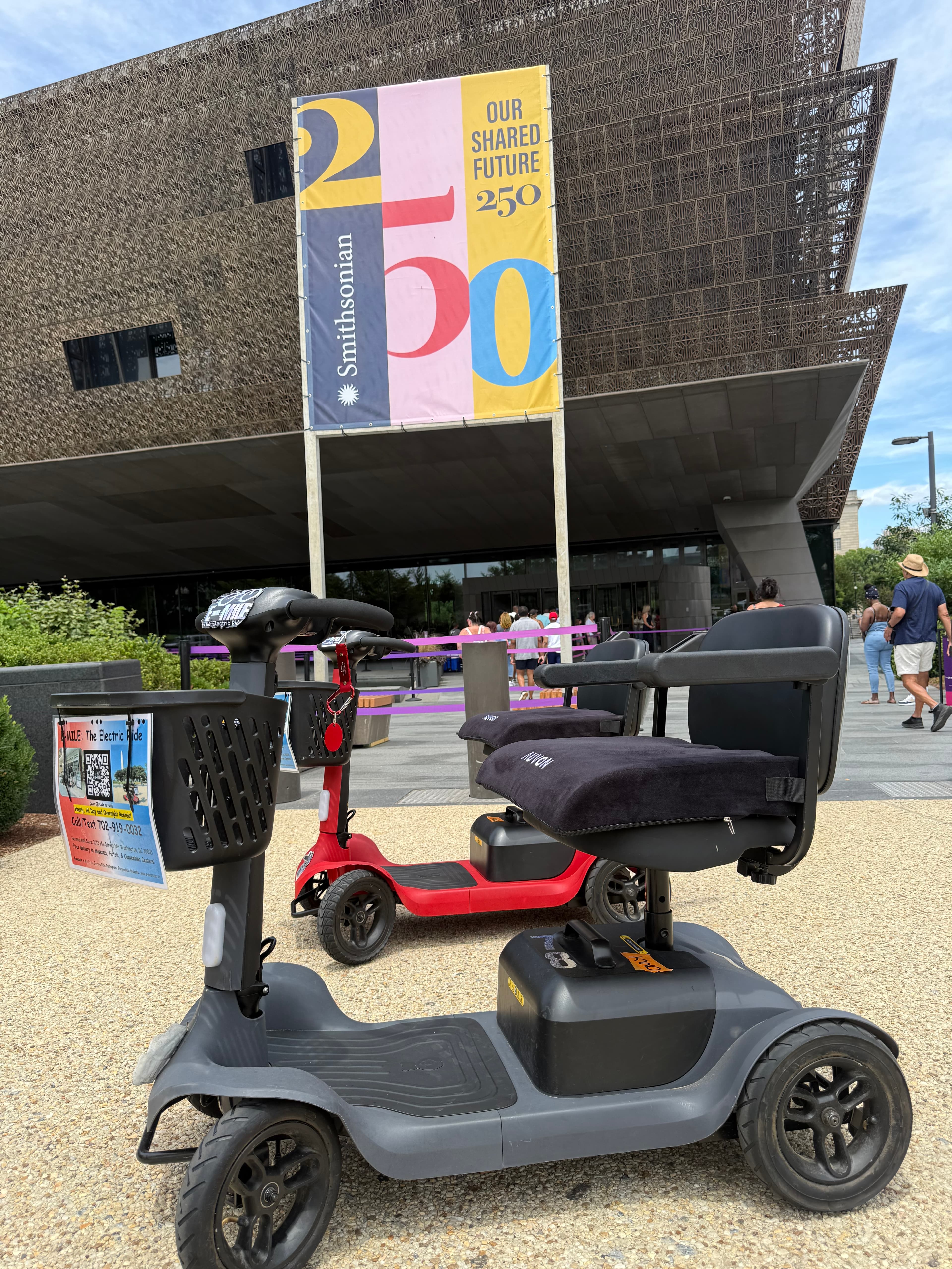 Mobility scooters parked outside the Smithsonian National Museum of African American History and Culture.
